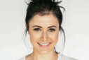 woman in white crew neck shirt smiling